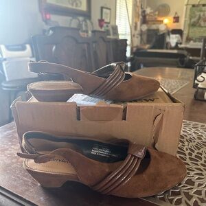 Brown suede like sling back shoes with buckle closure.